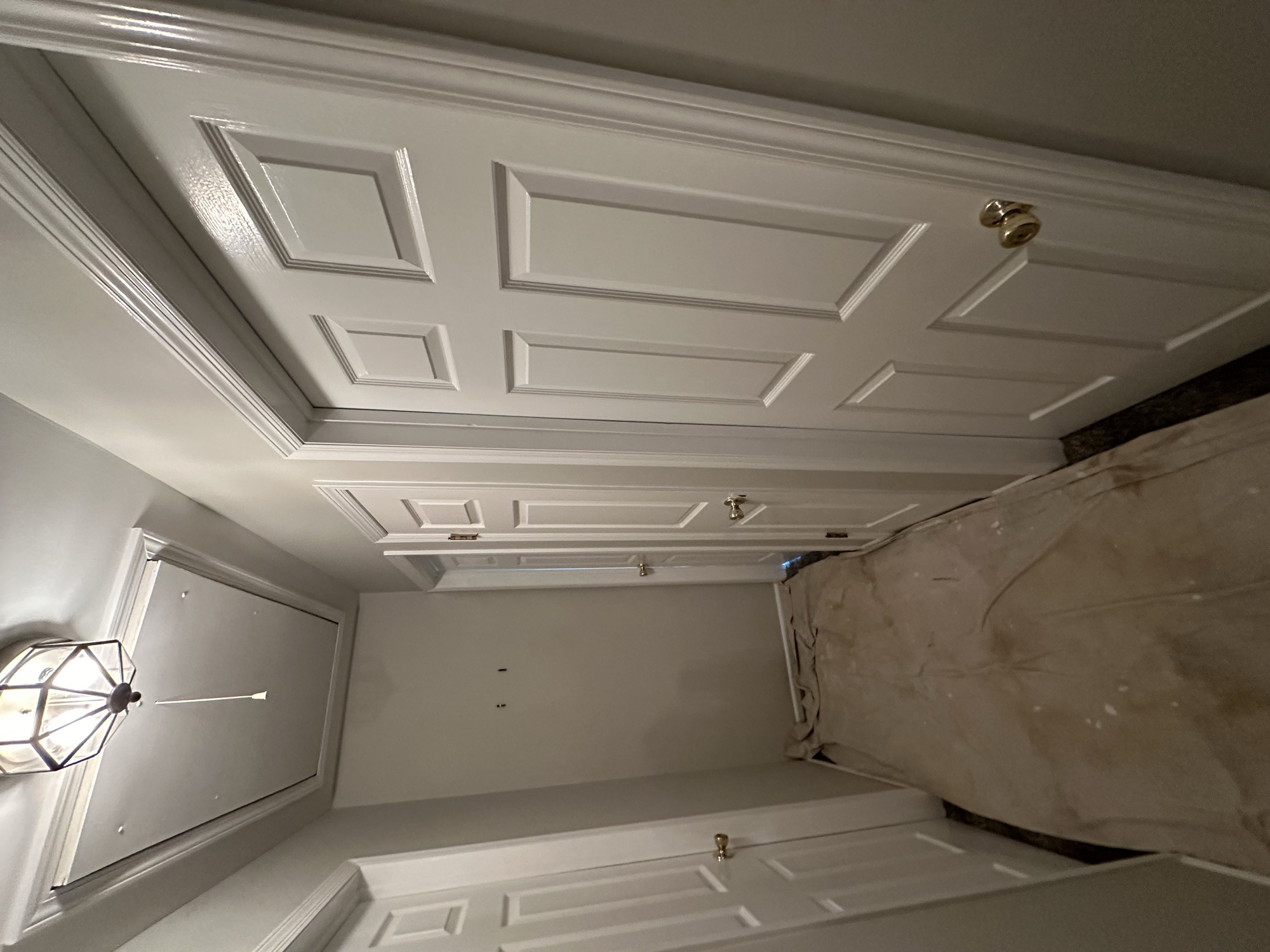 Elegant white paneled walls with decorative ceiling detail