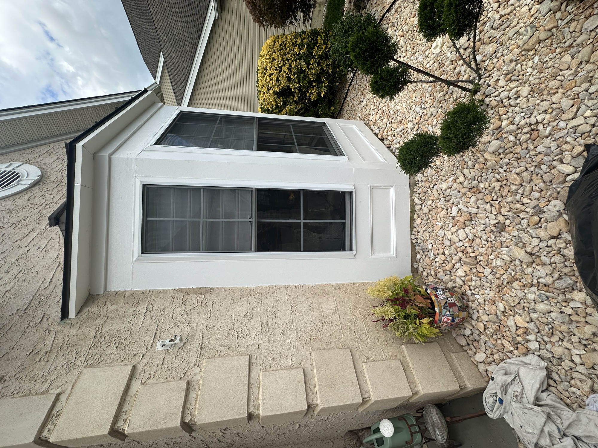 White bay window exterior trim painting detail