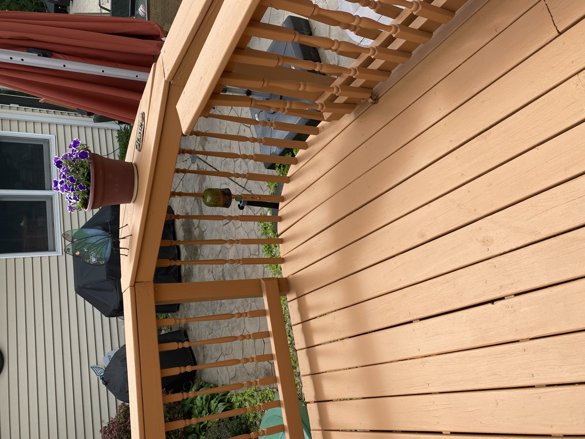 Stained wood pergola and deck with planters