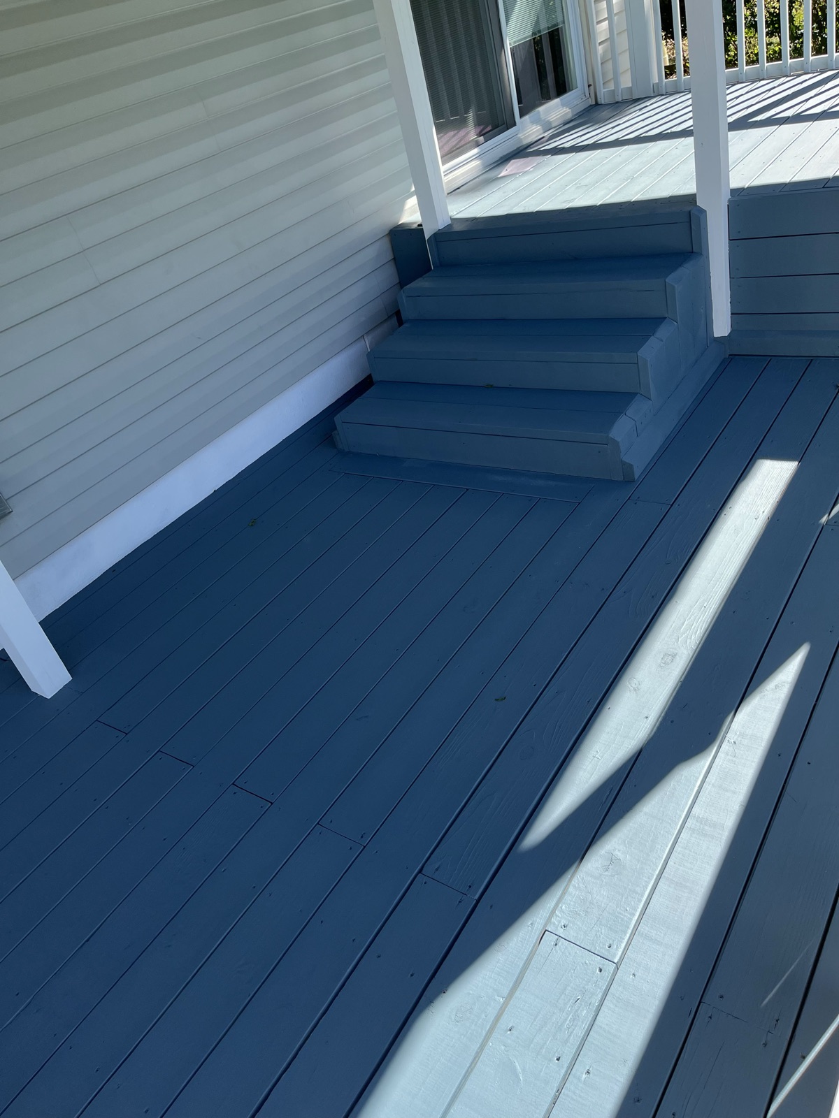 Blue painted porch steps with white trim