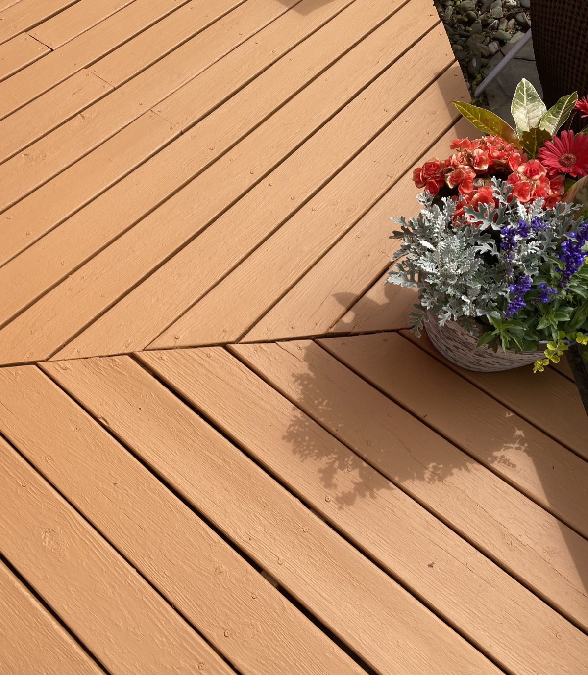 Stained herringbone pattern deck with flower pot