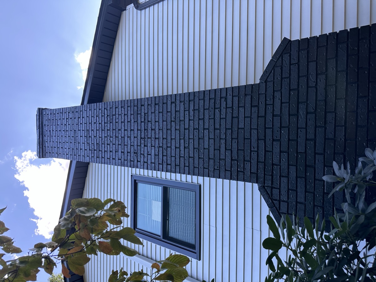 Two-tone exterior with dark painted brick accent