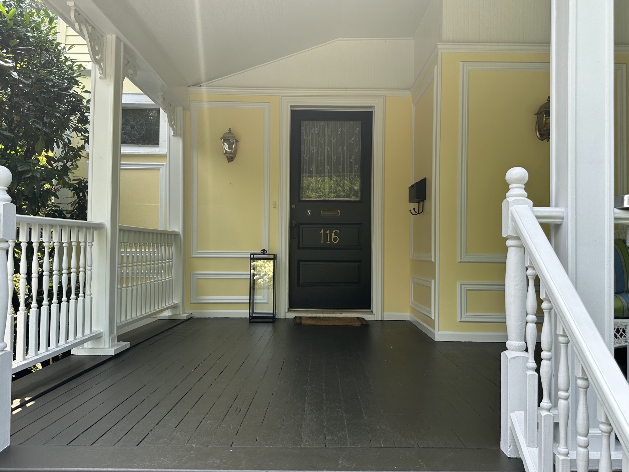 Victorian porch with detailed trim painting and painted floor