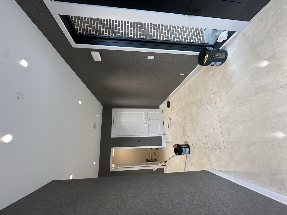 Dark accent wall with built-in shelving and recessed lighting