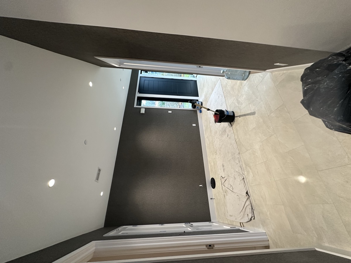 Dark charcoal accent wall with modern tile flooring